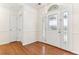 Bright foyer featuring hardwood floors and a decorative glass front door with sidelights at 1934 Mcconnell Rd, Grayson, GA 30017