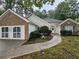 Charming single-story home featuring brick accents, white siding, and a well-manicured front yard at 1934 Mcconnell Rd, Grayson, GA 30017