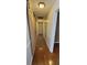 Hallway with wood floors, light fixtures, and a sliding barn door for added charm at 1934 Mcconnell Rd, Grayson, GA 30017