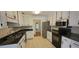 Bright kitchen with white cabinets, stainless appliances, and a tile floor at 1934 Mcconnell Rd, Grayson, GA 30017