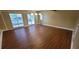 Large living room with hardwood floors, ample natural light, and a modern light fixture at 1934 Mcconnell Rd, Grayson, GA 30017