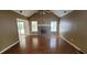 Spacious living room with a vaulted ceiling, brick fireplace, and hardwood flooring at 1934 Mcconnell Rd, Grayson, GA 30017