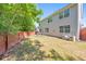 Large backyard featuring a well-maintained lawn, fenced perimeter, and outdoor seating area at 832 Topaz Vly, Canton, GA 30114