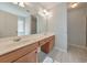 Well-lit bathroom featuring double sinks, wooden cabinetry, and a large mirror at 832 Topaz Vly, Canton, GA 30114