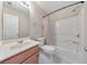 Bright bathroom with a single sink vanity, toilet, and shower-tub combo with a shower curtain at 832 Topaz Vly, Canton, GA 30114