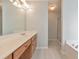 Bright bathroom featuring a vanity with a single sink, bathtub, and walk-in shower at 832 Topaz Vly, Canton, GA 30114