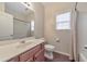 Neutral bathroom featuring a large mirror, a single sink vanity, and a shower-tub combo at 832 Topaz Vly, Canton, GA 30114