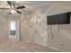 A view of the bedroom showcasing the ceiling fan, carpet flooring, mounted TV, and walk-in closet at 832 Topaz Vly, Canton, GA 30114