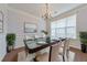 Elegant dining room with a modern glass table and decorative chandelier at 832 Topaz Vly, Canton, GA 30114