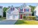 Attractive two-story home featuring a two-car garage and a well-manicured lawn at 832 Topaz Vly, Canton, GA 30114