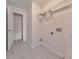 Bright laundry room with gray tile flooring and a wire shelf for storage at 832 Topaz Vly, Canton, GA 30114