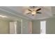 Open living room with tray ceiling, ceiling fan, and fresh paint at 832 Topaz Vly, Canton, GA 30114