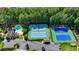 Aerial view showcasing community amenities: pool, clubhouse, tennis courts, and lush landscaping for an active lifestyle at 9810 Foxworth Dr, Alpharetta, GA 30022