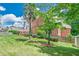 This is a backyard with a brick home, well manicured grass, and mature trees at 9810 Foxworth Dr, Alpharetta, GA 30022