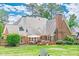 The backyard features a patio, seating area, green grass, and a brick home exterior at 9810 Foxworth Dr, Alpharetta, GA 30022
