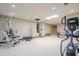 Basement featuring gym equipment, punching bag, and ample space for exercise and activities at 9810 Foxworth Dr, Alpharetta, GA 30022