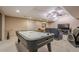 Basement including an air hockey table, recliners and entertainment center, with an exit door at 9810 Foxworth Dr, Alpharetta, GA 30022