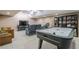 Entertaining basement with an air hockey table, large TV, comfortable seating, and built-in shelving at 9810 Foxworth Dr, Alpharetta, GA 30022