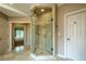 Luxurious walk-in shower with neutral tile, glass door, and easy access to the bedroom at 9810 Foxworth Dr, Alpharetta, GA 30022