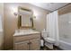 Cozy bathroom featuring a shower-tub combo, single sink vanity, and classic fixtures at 9810 Foxworth Dr, Alpharetta, GA 30022