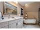 Stylish bathroom featuring a soaking tub, walk-in shower, and a modern vanity at 9810 Foxworth Dr, Alpharetta, GA 30022