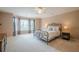 Spacious bedroom with large windows, plush carpet, and a decorative wrought iron bed frame at 9810 Foxworth Dr, Alpharetta, GA 30022
