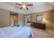 Bedroom featuring a ceiling fan, closet access, dresser, and plenty of natural light at 9810 Foxworth Dr, Alpharetta, GA 30022
