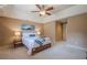 Relaxing bedroom with natural light, ceiling fan, stylish bedside lamps, and cozy decor at 9810 Foxworth Dr, Alpharetta, GA 30022