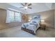 Comfortable bedroom with ceiling fan, natural light from the window, and stylish decor at 9810 Foxworth Dr, Alpharetta, GA 30022