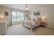 Cozy bedroom with light pink bedding, desk area, and bright natural light at 9810 Foxworth Dr, Alpharetta, GA 30022