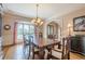 Spacious dining room with hardwood floors, elegant chandelier, and a large window at 9810 Foxworth Dr, Alpharetta, GA 30022