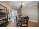 Dining room featuring a fireplace, wood flooring, and a view to another room at 9810 Foxworth Dr, Alpharetta, GA 30022