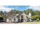 Community clubhouse featuring stone and stucco accents, plus a covered entry, for neighborhood residents' enjoyment at 9810 Foxworth Dr, Alpharetta, GA 30022