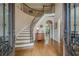 Grand foyer with curved staircase, hardwood floors, and elegant entry showcasing the home's interior at 9810 Foxworth Dr, Alpharetta, GA 30022