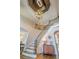 Elegant foyer featuring a winding staircase, chandelier, and sophisticated design at 9810 Foxworth Dr, Alpharetta, GA 30022
