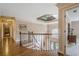 Elegant foyer showcasing hardwood floors, iron railing, and a view of the front entrance at 9810 Foxworth Dr, Alpharetta, GA 30022