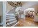 Grand foyer with a curved staircase, hardwood floors, and open view to the dining room at 9810 Foxworth Dr, Alpharetta, GA 30022