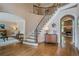 Spacious foyer showcasing curved staircase, hardwood floors, and elegant architectural details at 9810 Foxworth Dr, Alpharetta, GA 30022