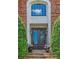 Elegant front entrance with custom iron doors, stone steps, and manicured greenery at 9810 Foxworth Dr, Alpharetta, GA 30022
