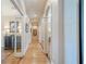 Hallway with archways, neutral paint and hardwood flooring at 9810 Foxworth Dr, Alpharetta, GA 30022