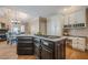 View of kitchen with large center island cooktop and open dining and fireplace area at 9810 Foxworth Dr, Alpharetta, GA 30022