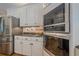 Kitchen with stainless steel refrigerator, double oven, granite countertops, and white cabinets at 9810 Foxworth Dr, Alpharetta, GA 30022