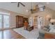 Open-concept living room boasting hardwood floors, a stone fireplace and lots of natural light at 9810 Foxworth Dr, Alpharetta, GA 30022