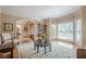 Bright living room features hardwood floors, large windows, and stylish decor at 9810 Foxworth Dr, Alpharetta, GA 30022