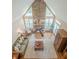 Aerial view of the inviting living room, stone fireplace, vaulted ceiling, and abundant light at 9810 Foxworth Dr, Alpharetta, GA 30022