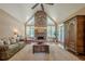 Inviting living room features a stone fireplace, vaulted ceiling, and natural light at 9810 Foxworth Dr, Alpharetta, GA 30022