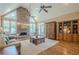 Spacious living room boasting a stone fireplace, hardwood floors, and ample seating at 9810 Foxworth Dr, Alpharetta, GA 30022