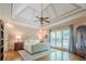 Main bedroom featuring hardwood flooring, a large ceiling fan, tray ceiling, and a large window at 9810 Foxworth Dr, Alpharetta, GA 30022
