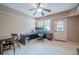 This is an office featuring a ceiling fan, large desk, carpet, and a door to the outside at 9810 Foxworth Dr, Alpharetta, GA 30022