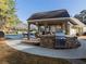 Community poolside grill with stone accents and covered seating for outdoor dining and entertainment for residents at 9810 Foxworth Dr, Alpharetta, GA 30022